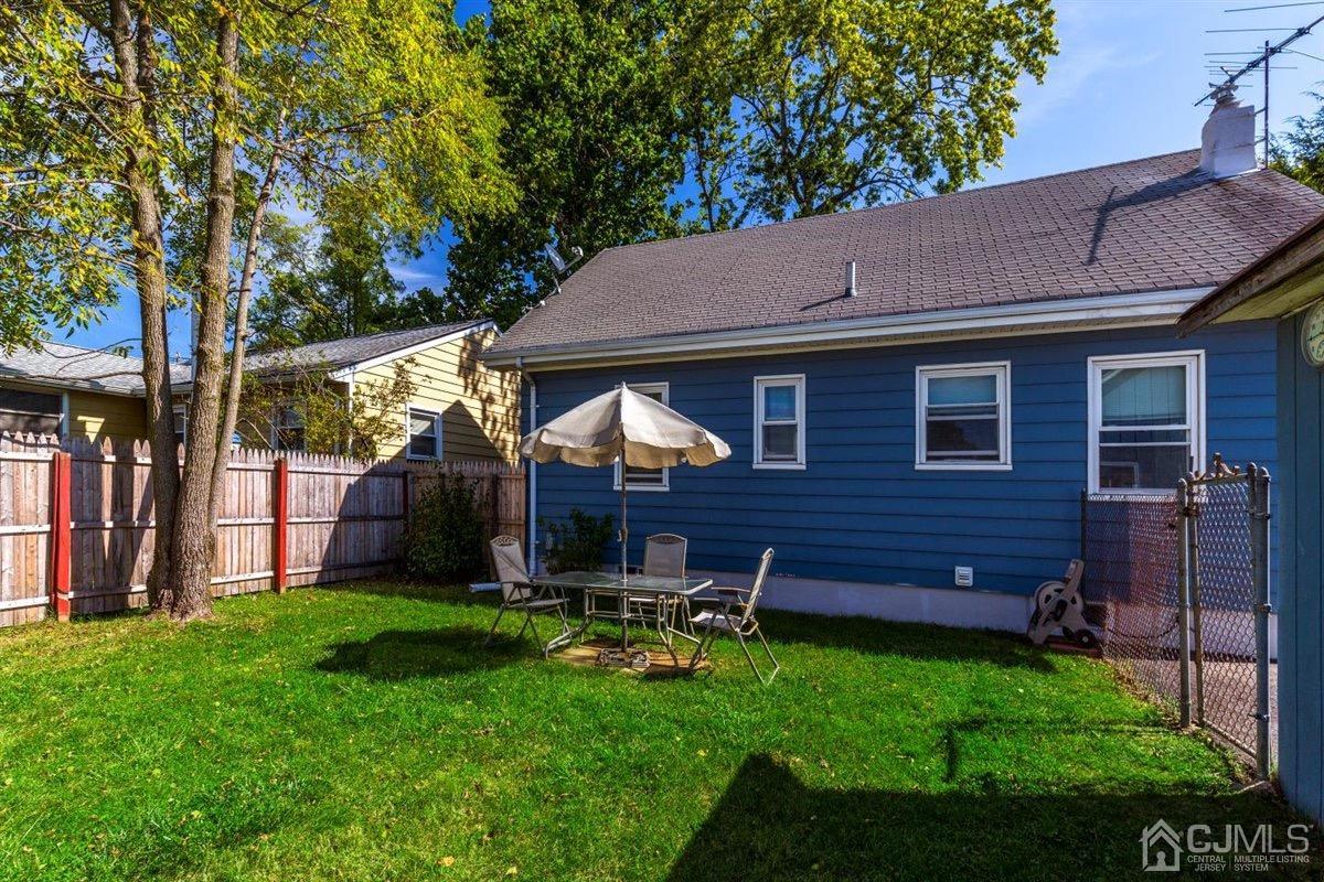 284 Old Post Road Edison, NJ 08817 - Photo 16 of 27 a backyard of a house with table and chairs