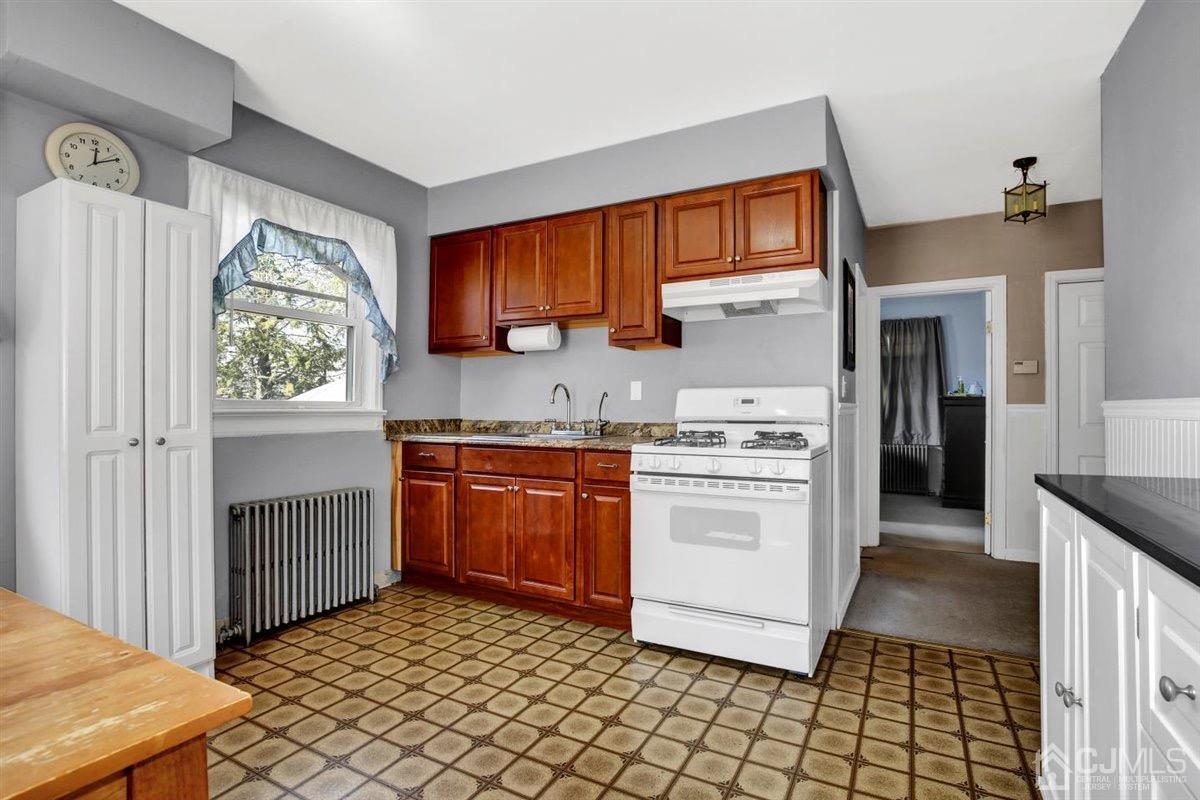 284 Old Post Road Edison, NJ 08817 - Photo 6 of 27 a kitchen with stainless steel appliances granite countertop a stove a sink and a refrigerator