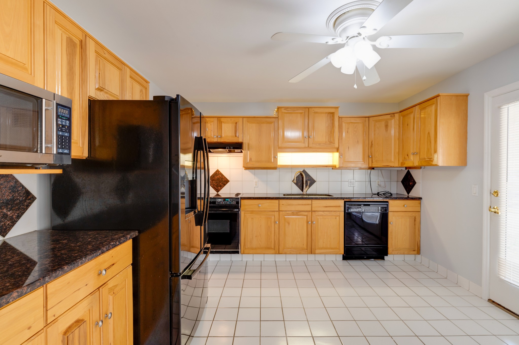 508 Ridgemont Drive Dickson, TN 37055 - Photo 11 of 44 a kitchen with stainless steel appliances granite countertop a refrigerator a stove top oven a sink dishwasher and wooden cabinets