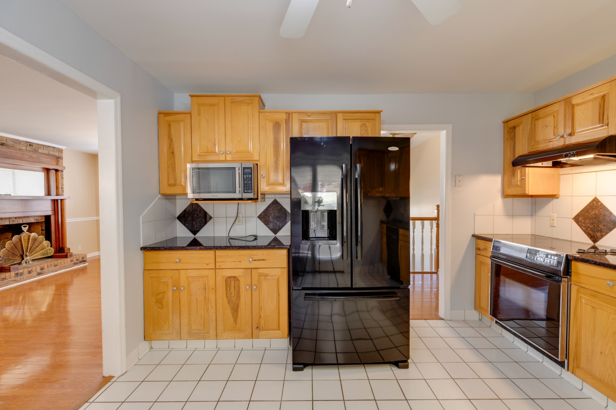508 Ridgemont Drive Dickson, TN 37055 - Photo 15 of 44 a kitchen with a refrigerator a stove top oven and cabinets