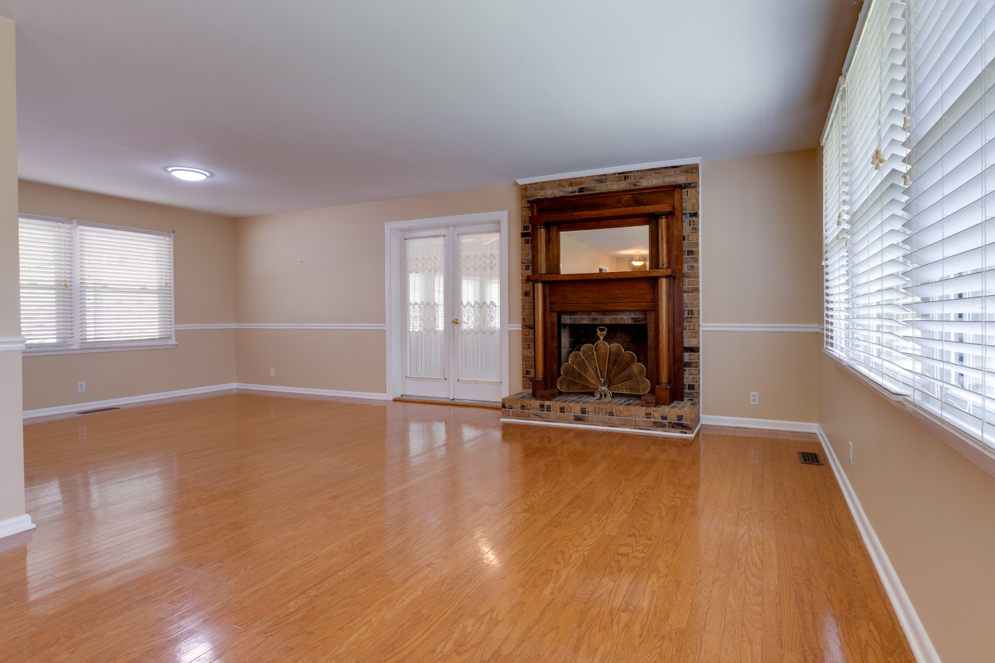 508 Ridgemont Drive Dickson, TN 37055 - Photo 7 of 44 an empty room with wooden floor cabinet and windows