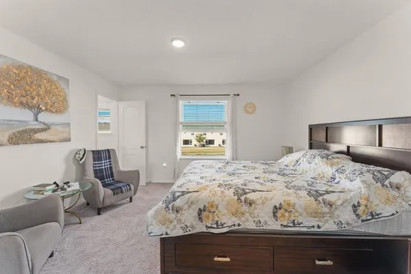 a bedroom with bed and window