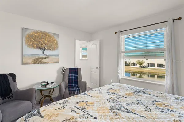 a bedroom with furniture and a window