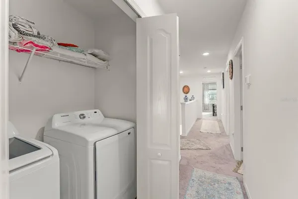 a view of storage and utility room with a washer dryer