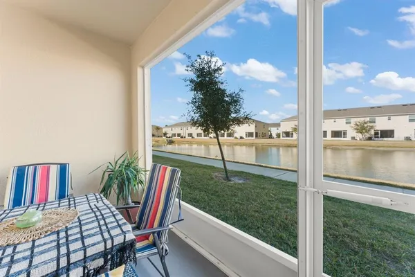 a view of a porch with furniture and garden