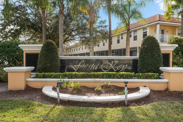 a view of a white house with a yard chairs and a fire pit