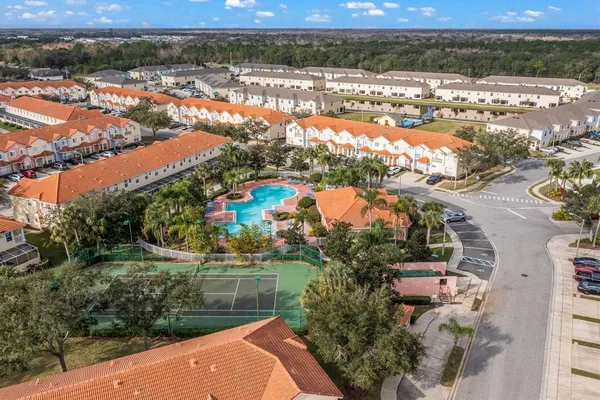 an aerial view of residential houses with outdoor space