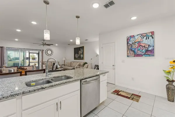 a kitchen with a sink window and cabinets