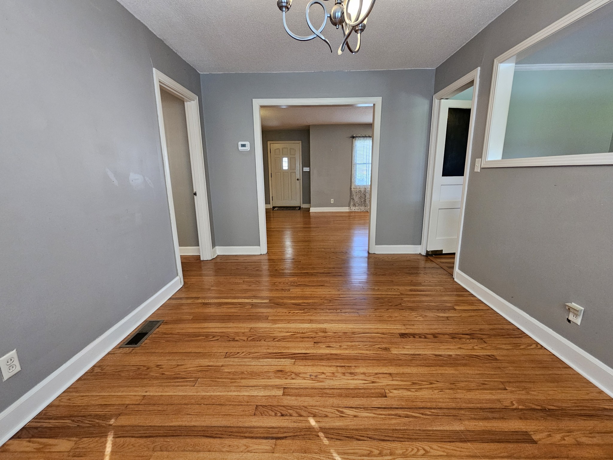 612 Jackson Avenue Carthage, TN 37030 - Photo 38 of 65 a view of a hallway with wooden floor and a chandelier