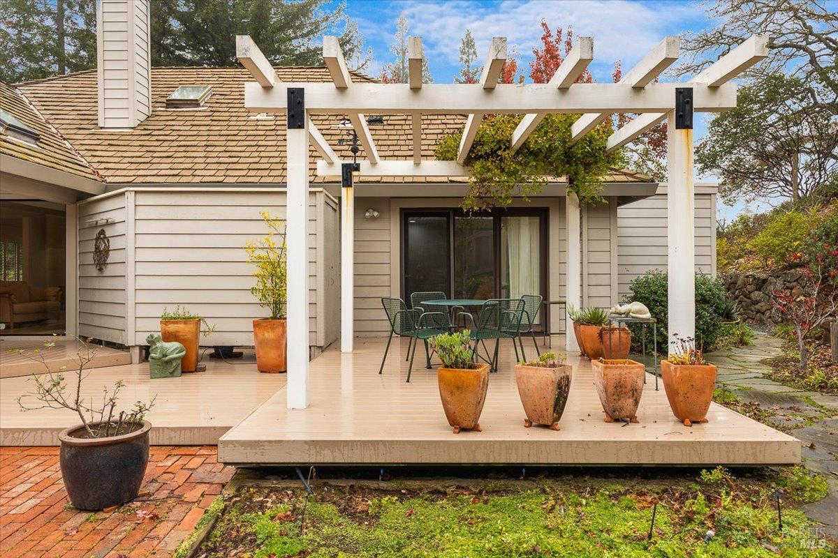 668 Wild Oak Drive Santa Rosa, CA 95409 - Photo 42 of 46 a view of a patio with dining table and chairs with potted plants