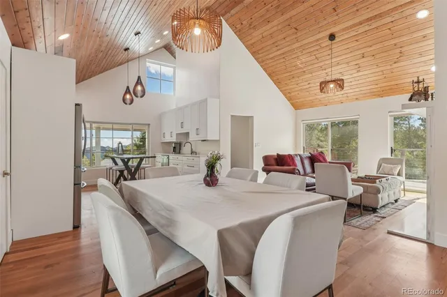 a large room with kitchen island a table and chairs