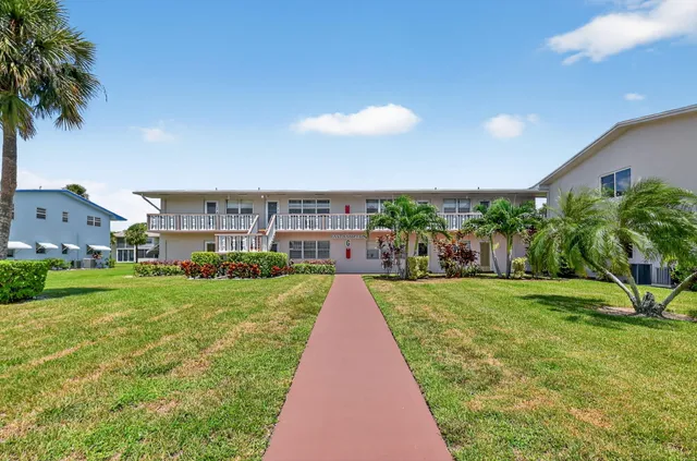 a view of a city in front of a house with a yard