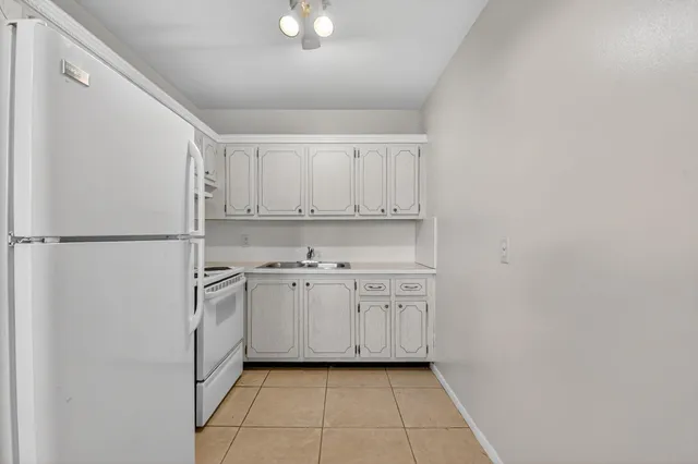 a kitchen with stainless steel appliances a sink and cabinets