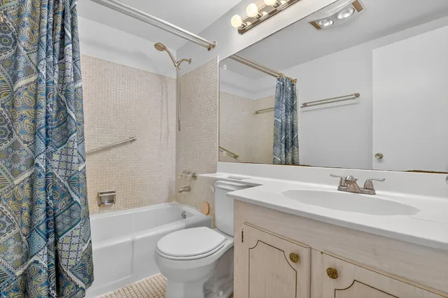 a bathroom with a sink toilet a mirror and shower