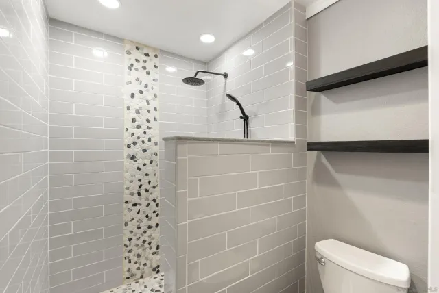 a bathroom with a shower and toilet
