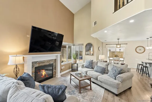a living room with furniture fireplace and flat screen tv