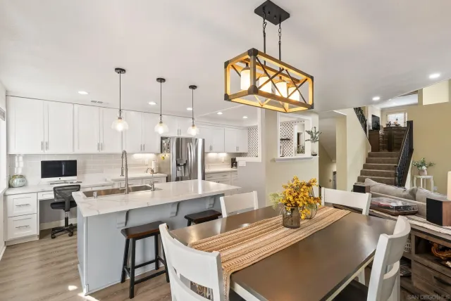 a view of a dining room with furniture and a chandelier