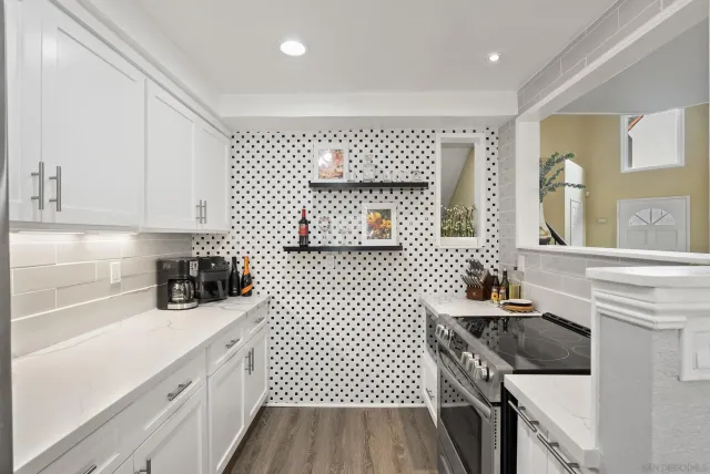 a kitchen with a sink stove and cabinets