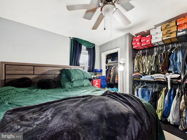 a bed room with a bed mirror and a chandelier