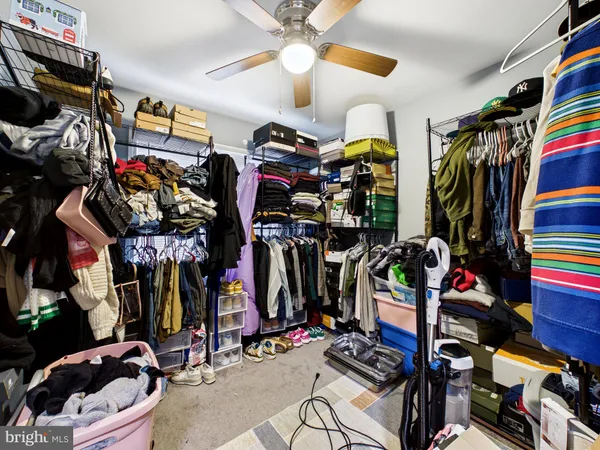 a view of walk in closet with clothes
