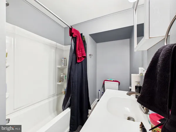 a hallway with a cabinet and a rug