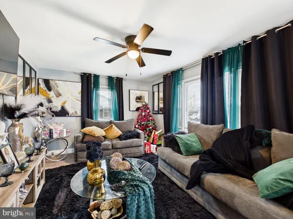 a living room with furniture chess floor and a window