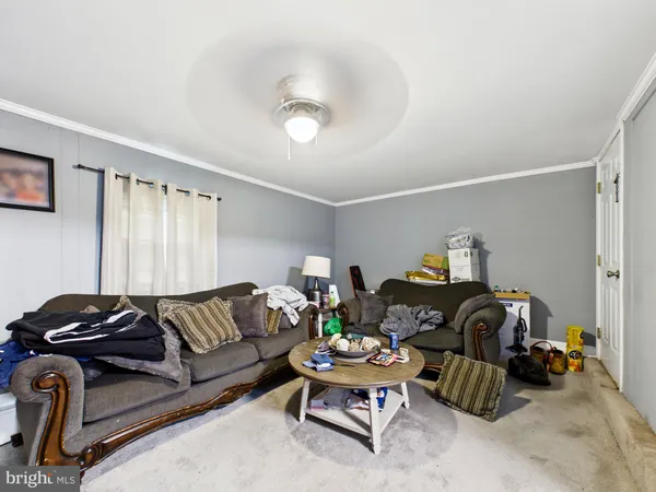 a living room with furniture a air conditioner vent and a window