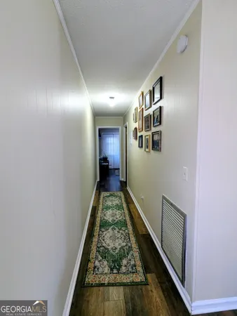 a view of hallway with wooden floor