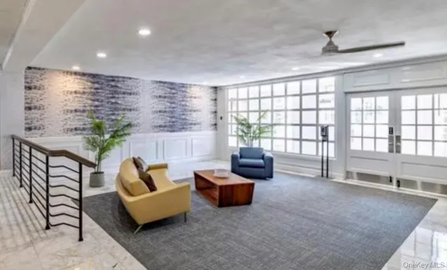 a living room with furniture and a floor to ceiling window