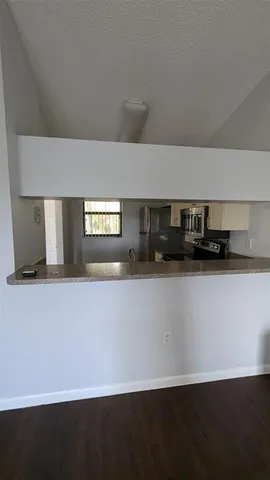 a close view of kitchen island a sink a refrigerator and window