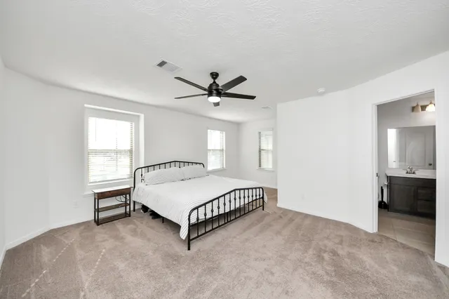 a bathroom with a double vanity sink a toilet and a bathtub
