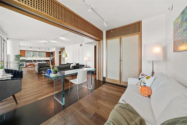 a view of a dining room with a floor to ceiling window and wooden floor