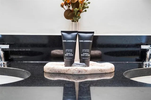 a bathroom with a granite countertop sink mirror vanity and toilet