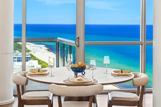 a hallway with furniture and a potted plant