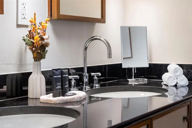 a view of hallway with wooden floor and cabinets