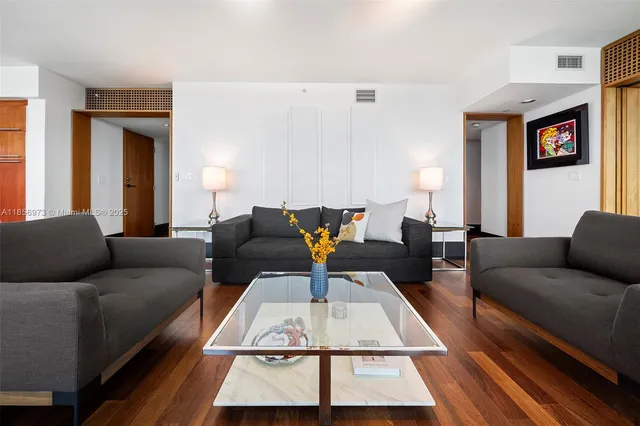 a living room with furniture and a floor to ceiling window