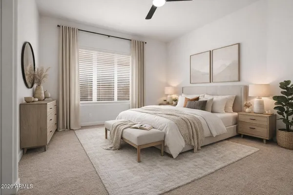 a spacious bedroom with a bed a couch and large window