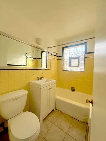 a bathroom with a toilet a sink and bathtub