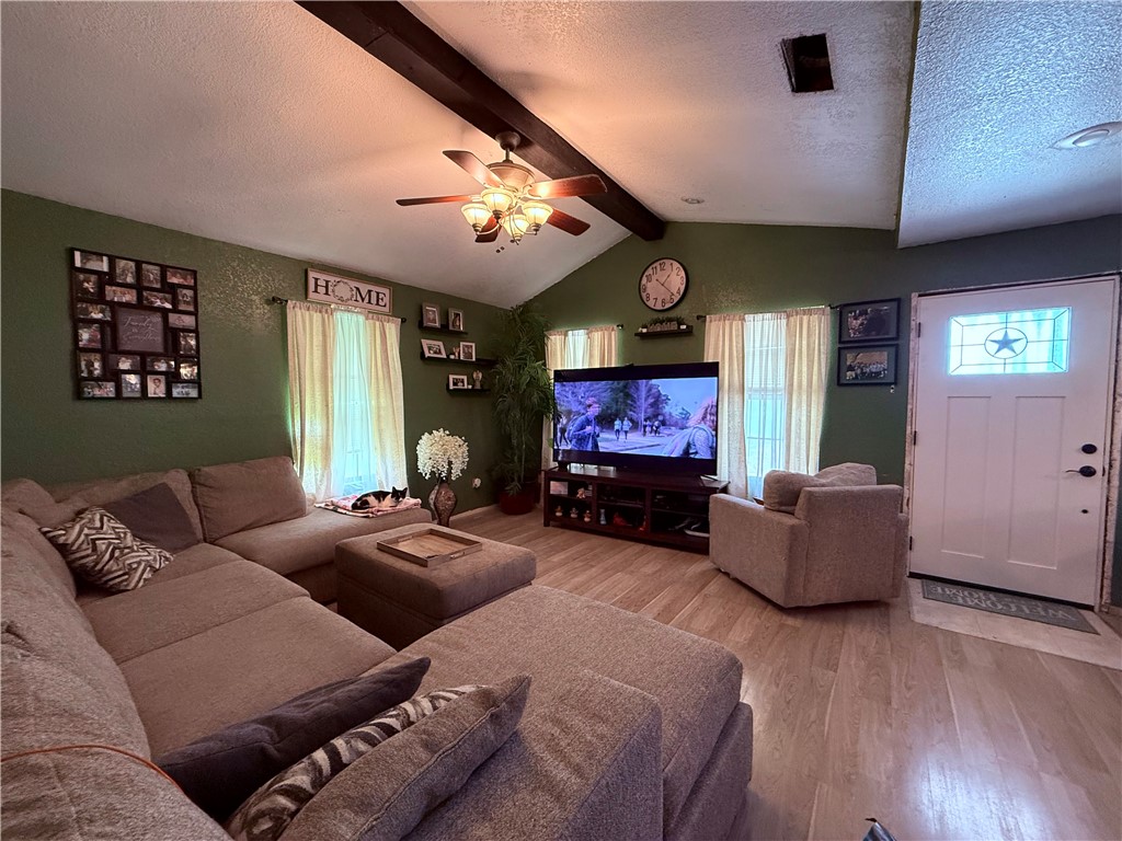 5742 Hidden Valley Loop Sandia, TX 78383 - Photo 12 of 32 a living room with furniture a large window and a flat screen tv