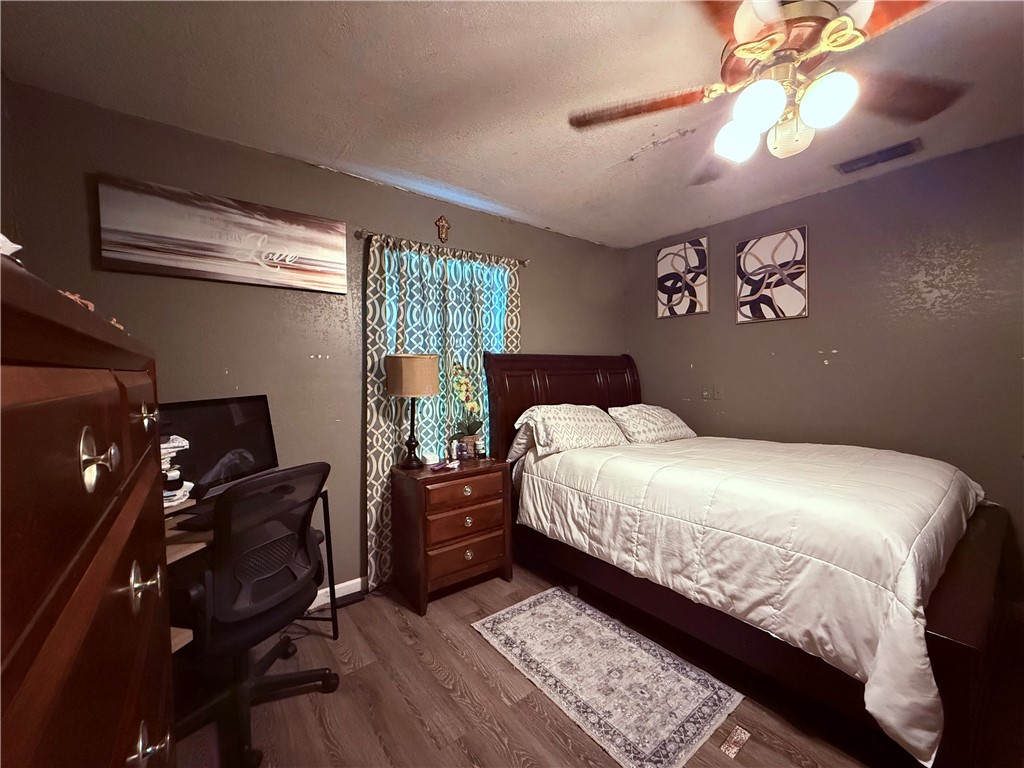 5742 Hidden Valley Loop Sandia, TX 78383 - Photo 13 of 32 a bedroom with a bed and a chandelier