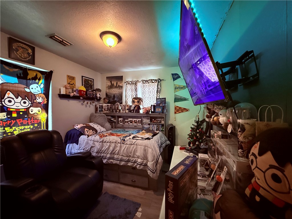 5742 Hidden Valley Loop Sandia, TX 78383 - Photo 15 of 32 a living room with furniture cabinets and a flat screen tv