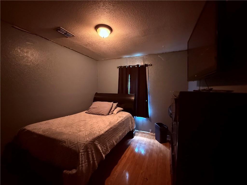 5742 Hidden Valley Loop Sandia, TX 78383 - Photo 17 of 32 a bedroom with a bed and a dresser