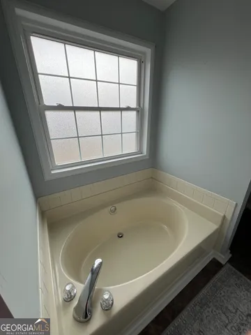 a bath tub sitting next to a window
