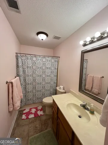 a bathroom with a sink a vanity and a mirror