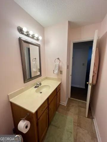 a bedroom with two beds and a chandelier