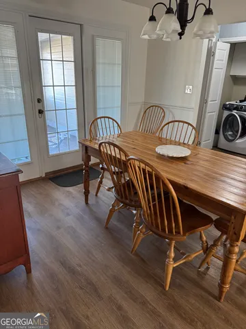 a view of a dining room with furniture and a window