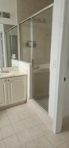 a bathroom with a shower and a sink
