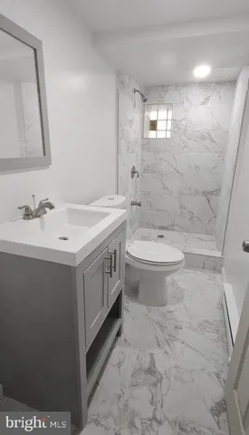 a bathroom with a double vanity sink toilet and a mirror