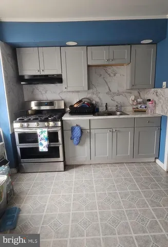 a kitchen with a stove a sink and a microwave