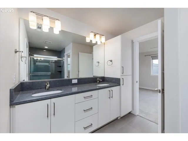 a bathroom with a shower and a sink